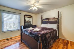 a bedroom with a bed and a ceiling fan at Pet-Friendly Roanoke Home with Fire Pit and Grill! in Roanoke