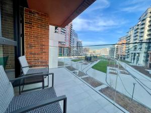 a balcony with chairs and a view of a street at Aglaya 3 - Luxury 2BR Apartment in Belgrade