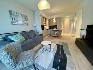 a living room with a couch and a table at Aglaya 3 - Luxury 2BR Apartment in Belgrade