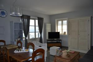 a living room with a table and a dining room at Solivonatural Apartment in Cannobio