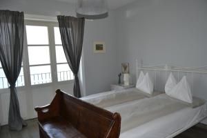 a bedroom with a white bed with a large window at Solivonatural Apartment in Cannobio