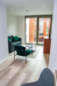 a living room with a couch and a table at Smart Central Birmingham 1 Bed Apartment in Birmingham