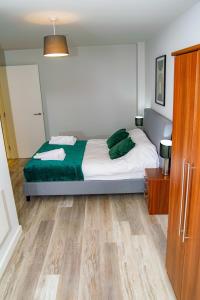 a bedroom with a bed and a wooden floor at Smart Central Birmingham 1 Bed Apartment in Birmingham