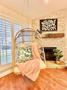 a swing in a living room with a fireplace at Comfortable Sleep 08 - Furnished Family Home with Spacious Backyard & Swing in Katy