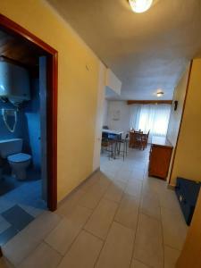 a room with a hallway with a table and a kitchen at Altissim Lake Placid in Pas de la Casa