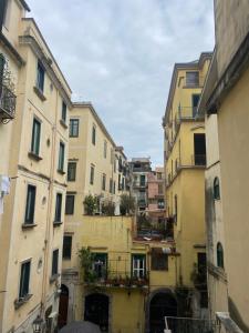 an alleyway between two buildings in a city at Al Conservatorio Vecchio in Salerno