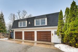 a house with two garage doors on a street at 7 Mi to Newark Montclair Vacation Rental in Montclair