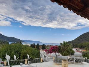 a view from the balcony of a house with a view of the water at Akdeniz Pansiyon in Ekincik