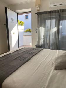 a bedroom with a large bed with a window at Airport Hotel in Fiumicino