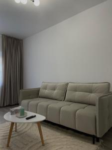 a living room with a couch and a coffee table at Neutral Nest in Sibiu +10 photos