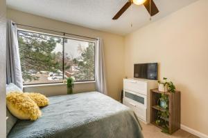 a bedroom with a bed and a large window at Beautiful Boulder Townhome Walk to CU and Pearl St! in Boulder