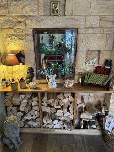 a stone wall with a wooden shelf and a mirror at The White Lion Hotel in Upton upon Severn