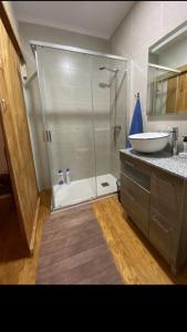 a bathroom with a shower and a sink at Casa de las Ascuas in Ourense