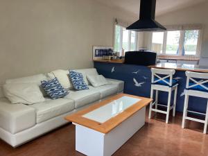 a living room with a white couch and a table at The Bird in Hand in Egerton