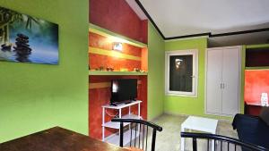 a living room with colorful walls and a television at Villas Canarias apartamento 310 in Adeje