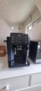 a black microwave sitting on top of a kitchen counter at DNT HOUSE 2 in Craiova