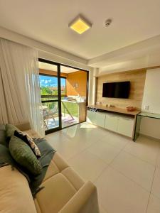 TV a/nebo společenská místnost v ubytování Flats Eco Resort Praia dos Carneiros