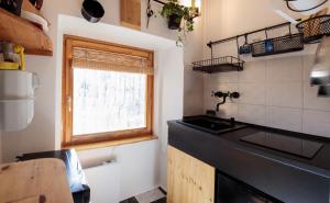 a kitchen with a black counter top and a window at Birdnest Apartment in Budapest