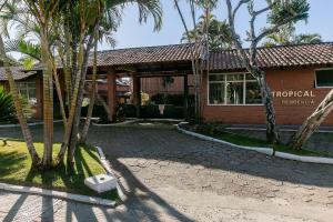 a building with palm trees in front of it at Residencial Tropical in Florianópolis