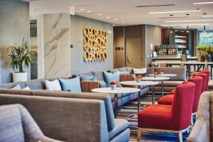 a restaurant with couches and tables and chairs at Hotel Trio Healdsburg in Healdsburg