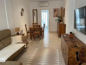 a living room with a couch and a television at Holiday Home Amari - Residencia Albatros in Los Alcázares