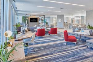 an office lobby with red chairs and couches at Hotel Trio Healdsburg in Healdsburg