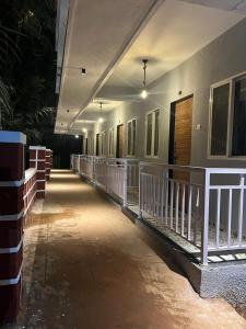 a hallway of a building with a white railing at SURYAPRABHA HOLIDAY HOMES in Diveagar