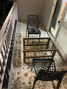 two chairs and a table on a tile floor at SURYAPRABHA HOLIDAY HOMES in Diveagar