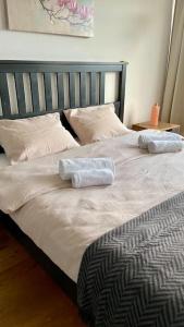 a bed with two towels on top of it at Gesamte Wohnung in Zurich in Kloten