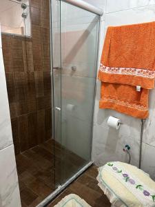 a shower with a glass door in a bathroom at dalton in Itacaré