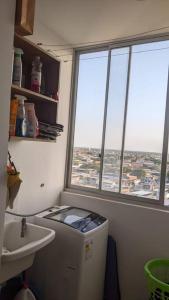 a small bathroom with a sink and a window at Apartamento en Piura - Perú in Piura