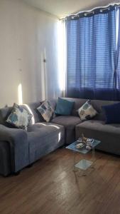 a living room with a couch and a table at Apartamento en Piura - Perú in Piura