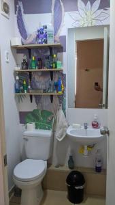 a bathroom with a white toilet and a sink at Apartamento en Piura - Perú in Piura
