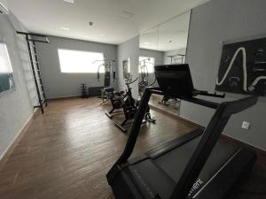a gym with a treadmill and bikes in a room at Flat Aconchegante 1 in Sorocaba