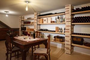 a dining room with a table and shelves of wine bottles at Luxurious 6- Bed Private Villa in Heraklion Crete in Athánatoi