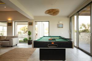 a living room with a pool table in it at Luxurious Retreat Villa in Heraklion Crete in Athánatoi
