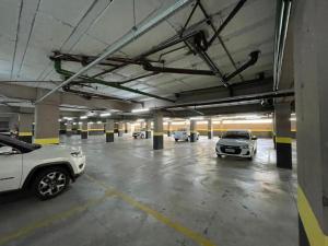 a parking garage with several cars parked in it at Flat Aconchegante 1 in Sorocaba
