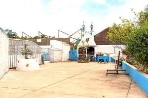 a playground in front of a building with a church at Algarve Quinta Estacao Alcantarilha Casa 1 e 2 in Alcantarilha