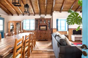 a dining room with a long table and chairs at Algarve Quinta Estacao Alcantarilha Casa 1 e 2 in Alcantarilha