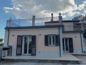 a house with a balcony on top of it at Abbentu in Zafferana Etnea