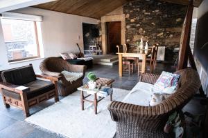 a living room with two chairs and a table at Casa da Ferreira_Vila Real in Vila Real