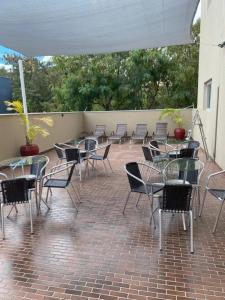 a group of tables and chairs on a patio at Flat Aconchegante 1 in Sorocaba