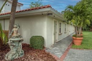 a home with a statue of a woman on a fountain at Shangri-La Springs in Bonita Springs