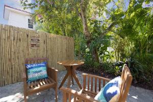 a patio with two chairs and a table and a fence at Shangri-La Springs in Bonita Springs