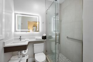 a bathroom with a shower and a toilet and a sink at Shangri-La Springs in Bonita Springs +18 photos