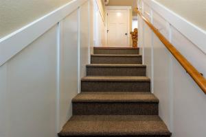 a stairway with a stair railing and a stair case at Cumberland Bungalow walking distance to downtown in Bend