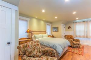 a bedroom with a bed and two chairs at Cumberland Bungalow walking distance to downtown in Bend