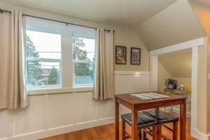 a dining room with a table and a window at Cumberland Bungalow walking distance to downtown in Bend +8 photos