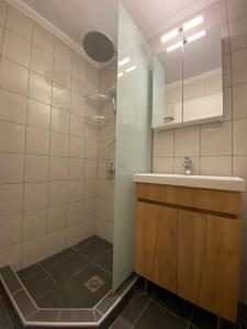 a bathroom with a sink and a shower at White Apartment in Kavala