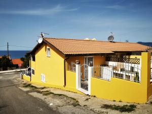 une maison jaune sur le côté d'une rue dans l'établissement La Casa Di Angelo, à Tresnuraghes